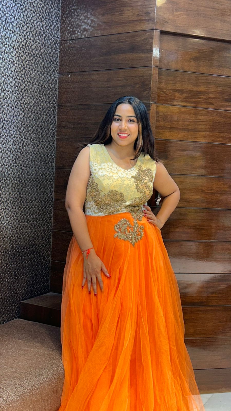 classy look orange net partywear gown